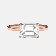 a rose gold ring with an emerald cut diamond