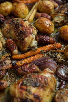 chicken, carrots and potatoes are being cooked in a skillet on the stove