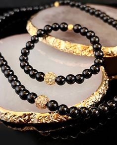 "Fall Season! Stretch jewelry! Easy on and off convenient wear!  Black Onyx AAA HIGH GRADE Bracelet name: Salem Bead Size: 6mm Shape: Round Center of stretch bracelet and necklace: 6mm Cubic Zirconia Pave Gold Bead Don't forget to take care of your jewels. -remove before showering -try to avoid chemicals, perfumes, oils & chlorine (pool time).  -clean your jewels with a lint free polishing cloth.  Sizing your wrist for your bracelets: You can use fabric measuring tape or just wrap a piece of str Bracelet Name, Pave Necklace, San Ramon, Pool Time, Cz Pendant, Measuring Tape, Beaded Stretch Bracelet, Stretch Bracelet, Bracelet Sizes