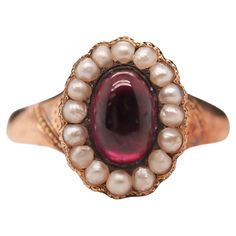 Year: 1863 (Engraved on inner shank) Item Details: Ring Size: 7 Metal Type: 9k Yellow-Rose Tone Gold [Hallmarked, and Tested] Weight: 3.0 grams Center Details: Tourmaline, Deep Purple, 7.7mm x 5.25mm, Natural Side Stone Details: Seed Pearls, 2mm each. Band Width: 2.55mm Condition: Excellent Victorian Etruscan Jewelry, Rose Tone, Garnet Jewelry, Jewelry Lookbook, Garnet Rings, Jewelry Rings Engagement, Yellow Roses, Ring Size 7, Pearl Ring