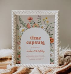 a white frame sitting on top of a wooden table