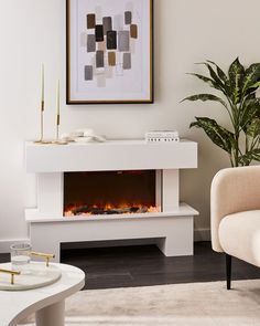 a living room with a white fireplace and chair in front of the fire place on the wall