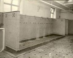 an old bathroom with urinals and tiled floors in black and white photo,