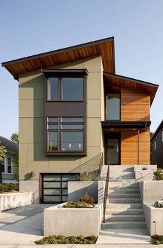 a two story house with stairs leading up to it