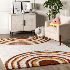 a living room with a rug, chair and potted plant