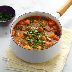 a white bowl filled with meat and vegetables