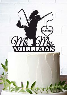 a wedding cake topper with the silhouette of a man and woman holding a heart