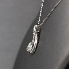 This little sparkler really brightens up your face! Gorgeous on its own and perfect layered with other necklaces, the peace features a delicate chain with a diamond pendant. The pendant is in a teardrop shape and is encrusted with round single cut prong set natural diamonds. The stones are F/G color and VS clarity. The diamond weight totals 0.21ctw. The chain and the pendant are crafted in 14k white gold and weigh a combined 1.53g. The chain measures 15" so it is shorter than average and will si Diamond Teardrop Necklace With Delicate Chain, Teardrop Diamond Necklace With Delicate Chain, Pendant Drop Necklace With Diamond Accents For Anniversary, Silver Teardrop Pendant Necklace With Single Cut Diamonds, Teardrop Single Cut Diamond Necklace For Anniversary, Anniversary Drop Necklace With Diamond Accents, Pendant Style, Anniversary Diamond Teardrop Pendant Necklace, Diamond Teardrop Pendant Necklace With Delicate Chain, Dazzling Diamond Necklace With Teardrop Pendant