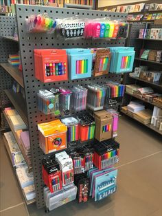 there are many different items on display in the store, including pens and pencils