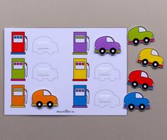 a card with different colored cars and trucks on it, next to a piece of cut out paper