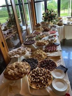 a long table filled with lots of pies and pastries