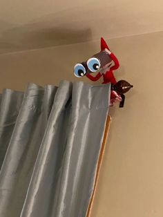 an image of a cartoon character peeking out from behind the curtain