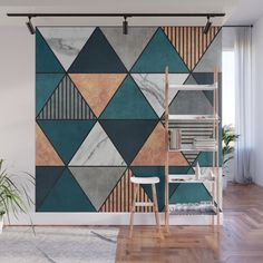 an abstract wall mural with geometric shapes in blue, brown and grey colors on a white background