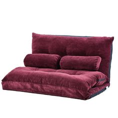 a futon sofa bed with two pillows on it