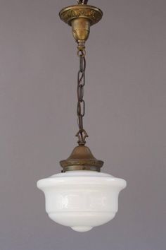 an old fashioned light fixture hanging from a ceiling