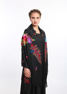 The woollen black shawl is covered with some statement floral illustrations, these lovely patterns are embroidered with silk threads by artisans of Kashmir Valley. It drapes elegantly down each shoulder or around the neck.  This wool shawl is designed to keep you cosy and stylish during the winter season. It redefines festive glamour with its nostalgic appeal, making it the perfect addition to elevate your style. Whether you're searching for a considerate winter gift or a versatile layering piec Kashmir Valley, Embroidered Shawl, Kashmiri Shawls, Wool Throw Blanket, Black Shawl, Indian Embroidery, Wool Shawl, Cashmere Wool, Floral Illustrations