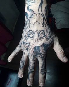 a hand with an octopus tattoo on it