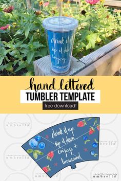 a blue tumbler cup sitting on top of a wooden table next to some flowers