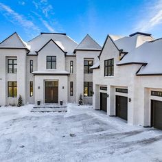 a large white house with lots of windows and snow on the ground in front of it