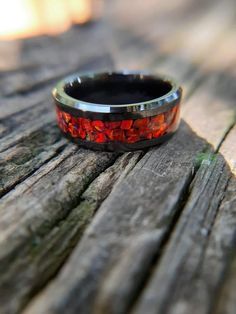 This beautiful, black ceramic ring features large chunks of red fire opal that have been thoughtfully arranged, one at a time, around the ring. The intense, ruby red is a beautiful contrast to the black ceramic band. The beauty of this ring is very difficult to depict in pictures. The red, lab grown opal reflects and refracts the light as you move the ring revealing deep, ruby-red colors highlighted by yellow and orange colors that pop out as the ring is moved in the light. It's sure to catch th Red Sand Beach, Red Lab, Opal Wedding Band, Mens Wedding Bands Unique, Opal Wedding, Black Wedding Band, Ceramic Ring, Types Of Opals, Black Ring