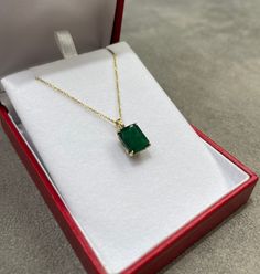 Displayed is a classic Colombian emerald solitaire necklace set in 14K yellow gold. This gorgeous solitaire pendant carries a large 4.92-carat emerald in a four-prong setting. The gem has a dark green color and very good luster. An ideal solitaire, perfect for everyday use! Setting Style: Solitaire - Prong Setting Material: 14K Yellow Gold Main Stone: Emerald Shape: Emerald Cut Approx Weight: 4.92-carats Color: Dark Green Clarity: Translucent Luster: Very Good Origin: Brazil Treatments: Natural, Yellow Gold Emerald Cut Solitaire Necklace, 14k Gold Emerald Cut Solitaire Necklace, Emerald Cut Solitaire Necklace In 14k Gold, Classic 14k Gold Necklace With Emerald Cut, 14k Gold Solitaire Necklace With Emerald Cut Diamond, Classic Formal Emerald Necklace With Hallmark, Classic Formal Emerald Necklace Hallmarked, Classic Formal Hallmarked Emerald Necklace, Classic Formal Emerald Necklace