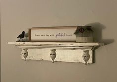 a shelf with two birds on top of it and a sign that says, there is only one bird left