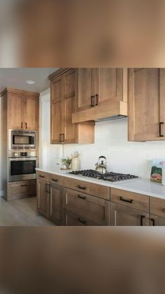 an image of a kitchen setting with wood cabinets and stainless steel appliances on the counter