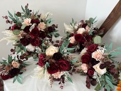 wedding bouquets with red and white flowers on a table