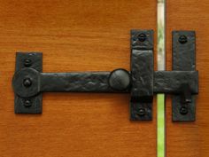 a close up of a door handle on a wooden door