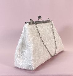 "This is a beautiful bridal lace clutch bag. It is perfect for the upcoming wedding season. It has been carefully made with high quality materials. Perfect accessory to compliment a range of outfits. It is large enough to hold your essentials (phone, keys, money/cards and lip stick. Designed from high end sequins lace fabric over off white satin and lined in white satin lining with one pocket inside. The interlining and interfacing used, help the bag hold its structure and maintain its shape rea Elegant Bridal Accessories With Lace Trim, Elegant Bridal Accessories With Delicate Lace For Party, Elegant Lace Bridal Accessories For Evening, Elegant Lace Bridal Accessories For Ceremony, Elegant Bridal Accessories With Lace Trim For Party, Elegant Bridal Accessories With Delicate Lace For Ceremony, Elegant Delicate Lace Bridal Accessories For Ceremony, Formal Lace Bridal Accessories, White Feminine Evening Bag For Wedding