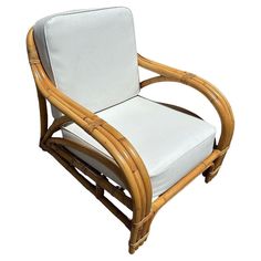 a chair made out of bamboo and white fabric with a seat cushion on the back