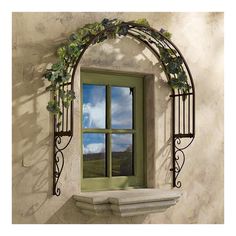 a window with vines on the side and a sink below it in front of a white wall