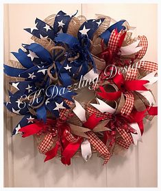 a patriotic wreath with red, white and blue ribbons