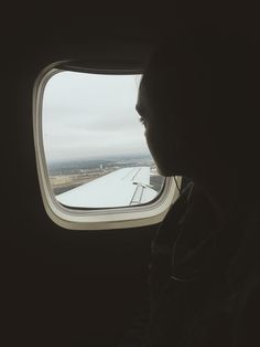 a person is looking out an airplane window