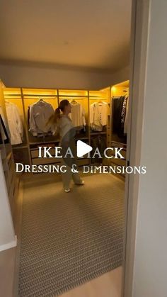 a woman standing in front of a closet filled with clothes