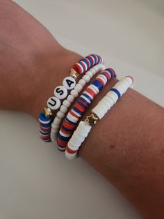 three bracelets with numbers on them sitting on a person's arm