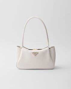 Leather handles Metal hardware Enameled metal triangle logo on the front Zipper closure Fabric logo-print lining with three compartments White Summer Bag, Luxurious Bags, White Purse Aesthetic, Designer Products, Bags Prada, Hand Bag Outfit, Bag Shoulder, White Bag Aesthetic