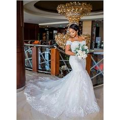 a woman in a white wedding dress holding a bouquet