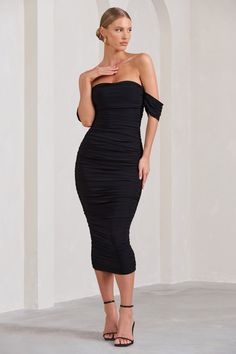 Leave wedding guests lost for words in this aptly-named midi dress. Designed in a breathtaking Bardot silhouette, Lost For Words boasts a bodycon fit made from stretchy ruched jersey. Style this black off-shoulder dress with simple accessories like clear slip-on pumps and let your sculpted curves be the overall focus. Features- Premium stretch jersey- Fully ruched- Bodycon fit- Invisible zip closure- Midi lengthSizing & Fit Model is 5'8" and wears UK Size 8 / US Size 4_Product InformationDesigned exclusively by Club L LondonDouble layered with excellent stretchPremium jersey in Black (95% Polyester, 5% Elastane)140cm total lengthSKU: CL126195002 One Shoulder Black Dress Knee Length, Little Black Dress Classy Hair Up, Rouched Cocktail Dress, Black Off Shoulder Dress, Lost For Words, Draped Midi Dress, Midi Bridesmaid Dress, Velvet Prom Dress, Draped Midi Dresses