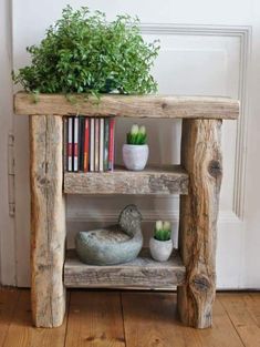 a wooden shelf with books and plants on it