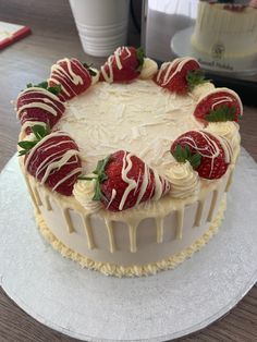 a white cake with strawberries and icing on top