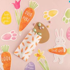 an assortment of stickers on a pink background with bunny, carrots and flowers