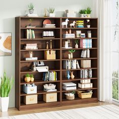 a bookshelf filled with lots of books in a living room next to a window