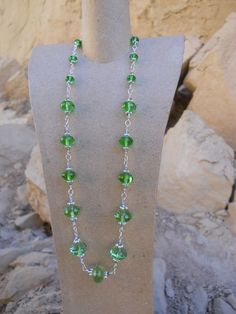 "Sale 40 Percent Off Inspired by the Tudors Elizabethan Steampunk Necklace and Earrings in Peridot Green Czech Crystal and Sterling Silver Originally inspired by the royal necklaces of state featured in the Showtime cable series \"The Tudors,\" this beautiful and sparking emerald green Swarovski and Czech crystal necklace accented with sterling silver will make you feel like a princess. Also a wonderful complement to any Victorian or steampunk wardrobe. Sterling silver beads from the Thailand Hill Tribes give an exotic feel. Hand crafted by a native San Diego using sterling silver wire. The matching earrings also have sterling silver hooks for your comfort and measure 3 cm (about 1.5 inches). The crystals are a deep emerald green that will have viewers mesmerized. The necklace measures 51. Green Wire Wrapped Jewelry For Party, Green Nickel-free Costume Jewelry, Royal Necklaces, The Tudors, Choker Collar Necklace, Green Beaded Necklace, Steampunk Necklace, Peridot Green, Swarovski Necklace