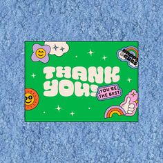 a thank you sticker on a blue background with stars and rainbows around it