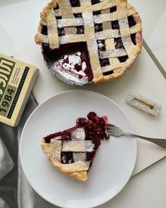 two pies sitting on top of a white plate next to each other, one with a bite taken out of it