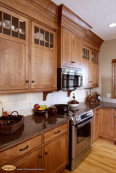 a kitchen with wooden cabinets and stainless steel appliances