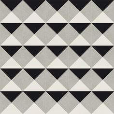 black and white triangles are arranged in an abstract pattern on the wall, as if they were made out of cement