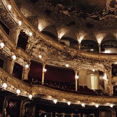 an ornately decorated auditorium with chandeliers and lights