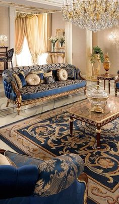 a fancy living room with blue couches and chandelier